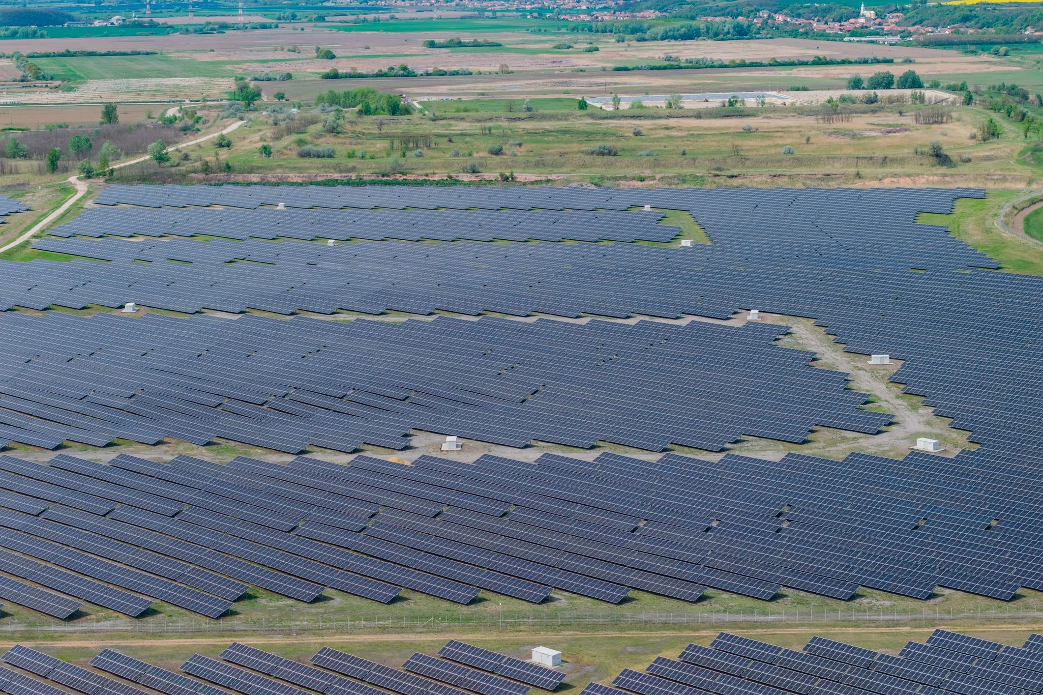 Aerial view of a large solar farm in a rural landscape
